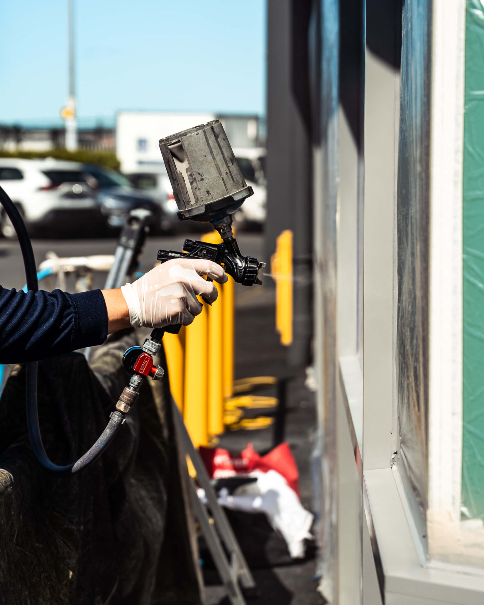 wrnz-walmsley-centre-joinery-coating-02.jpg WRNZ team applying protective coating to commercial aluminium joinery